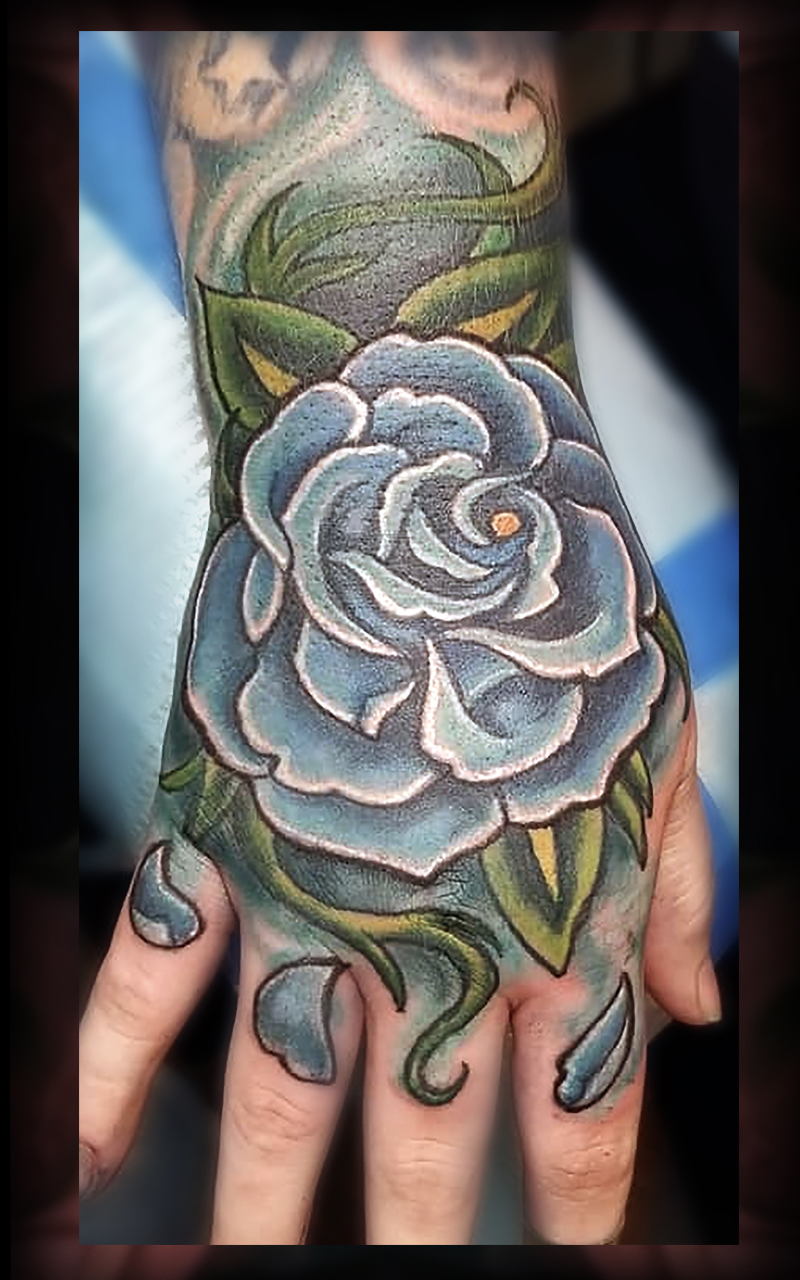 Blue rose on hand tattoo