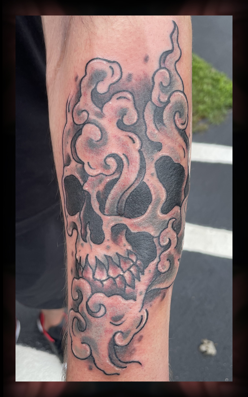 Skull inside smoke tattoo